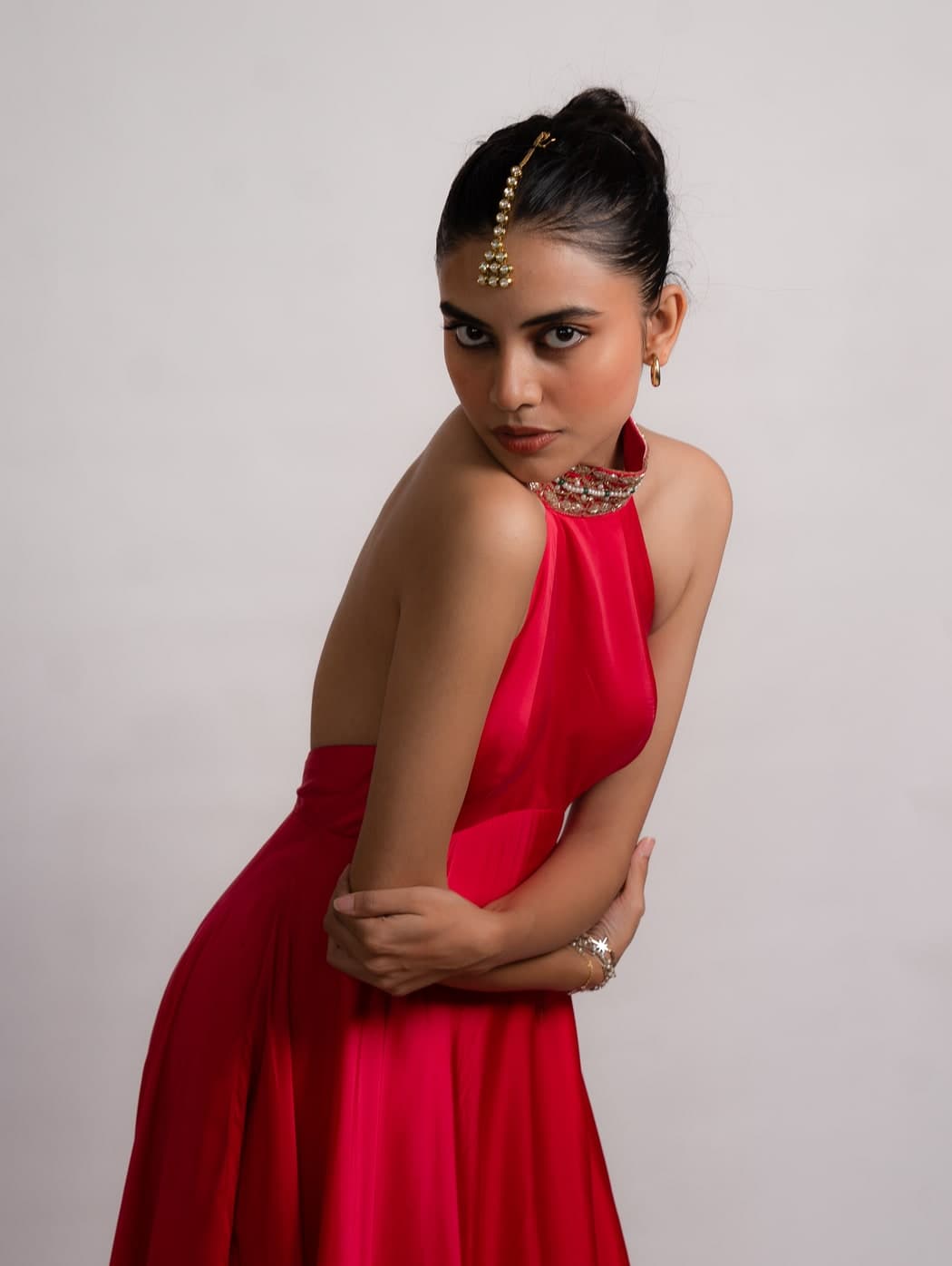 Raisa anarkali in pink, standing, showing the embroidered halter collar from the side
