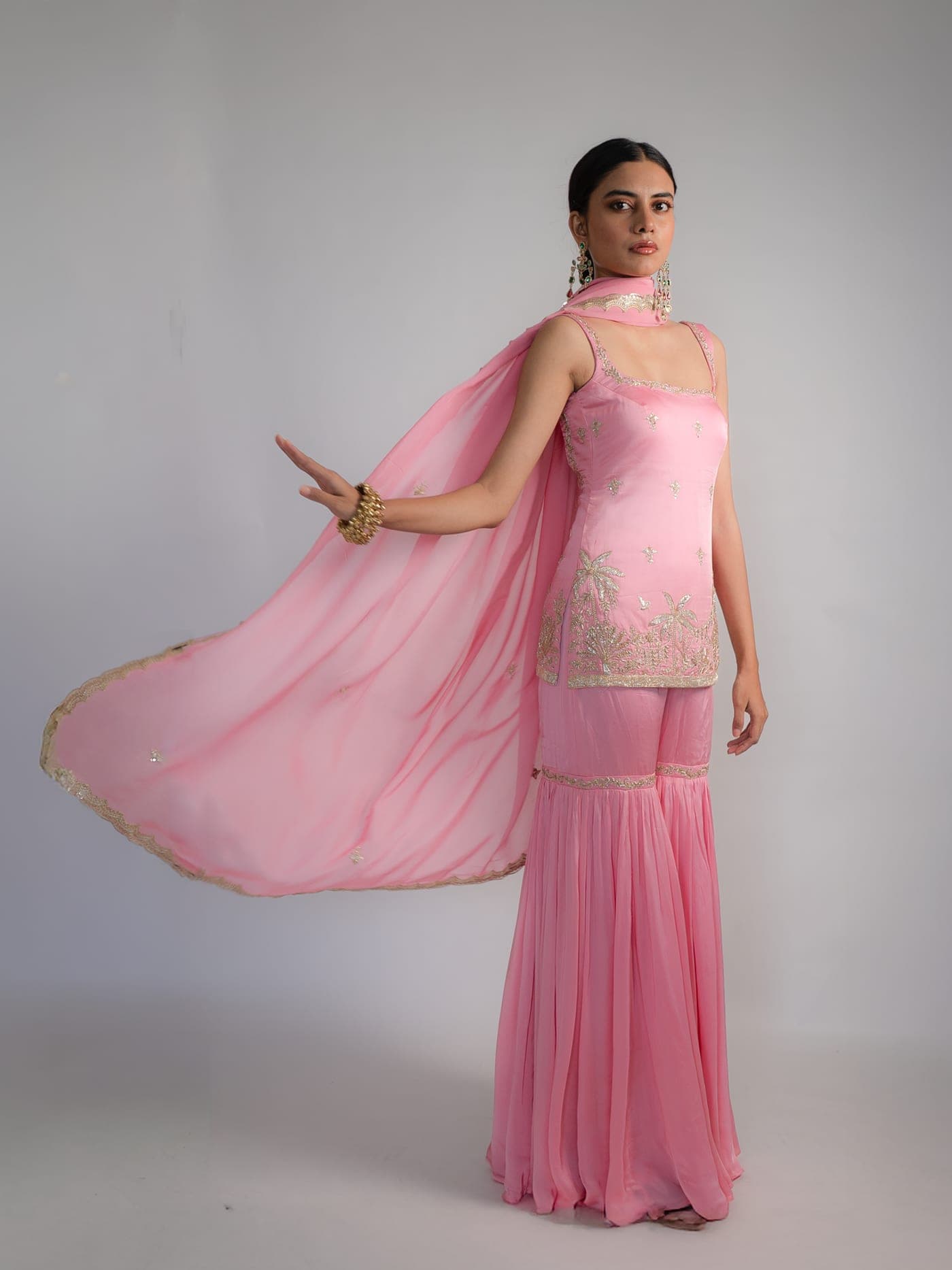 Geet sharara set in pink, full length, the dupatta caught in movement